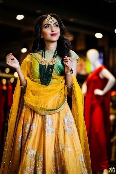 Photo of Yellow and green mehendi lehenga with dark green jewellery