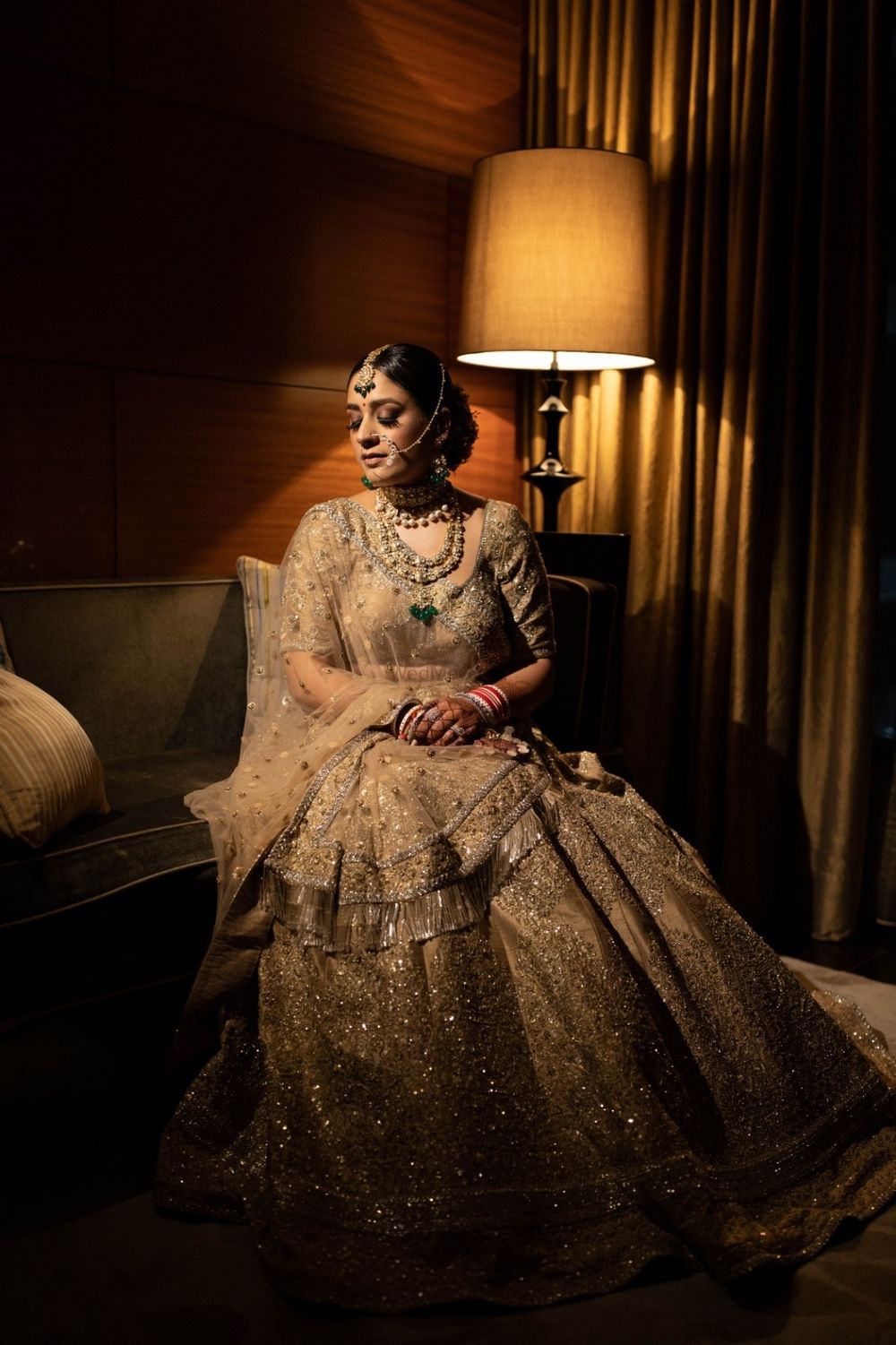 Photo of Bride dressed in a gold lehenga.