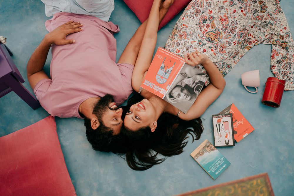 Photo of intimate pre wedding shoot idea at home with books