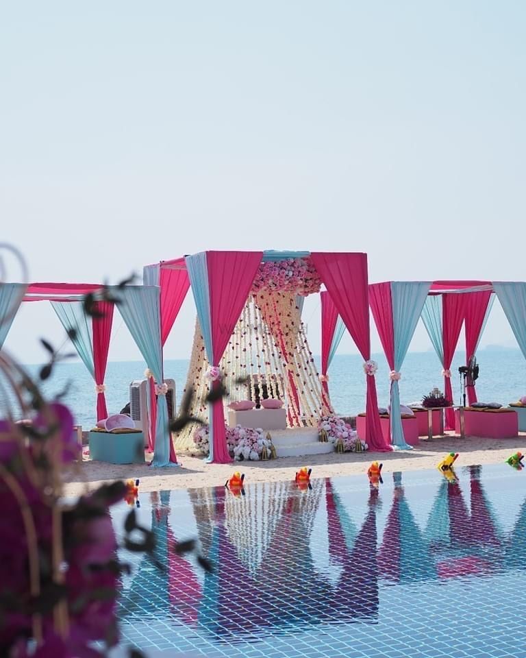 Photo of bright pink and light blue theme mehendi decor seating idea for bride