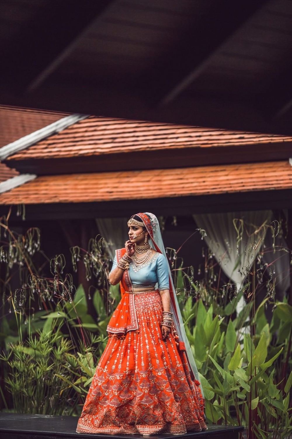 Photo of A bride in a lehenga with a contrasting blouse
