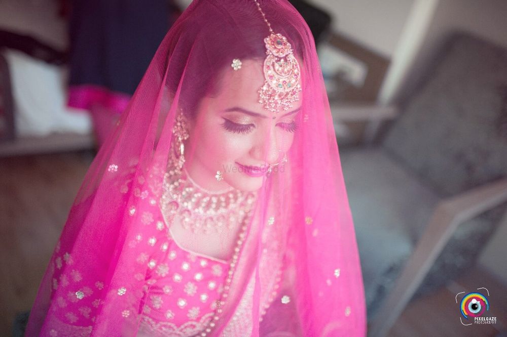 Photo of Wedding day bridal portrait with dupatta as veil