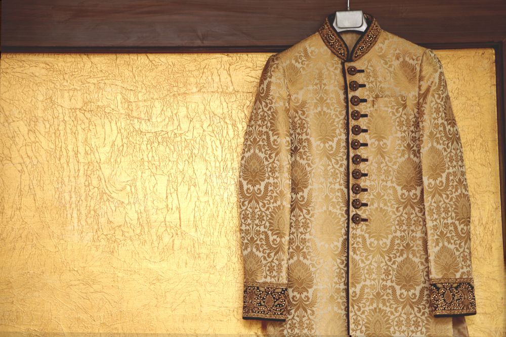 Photo of Cream and Gold Sherwani on a Hanger