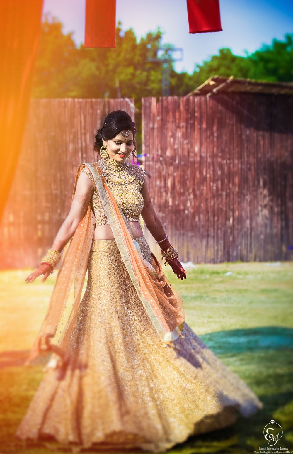 Photo of Gold lehenga with high neck blouse and peach dupatta