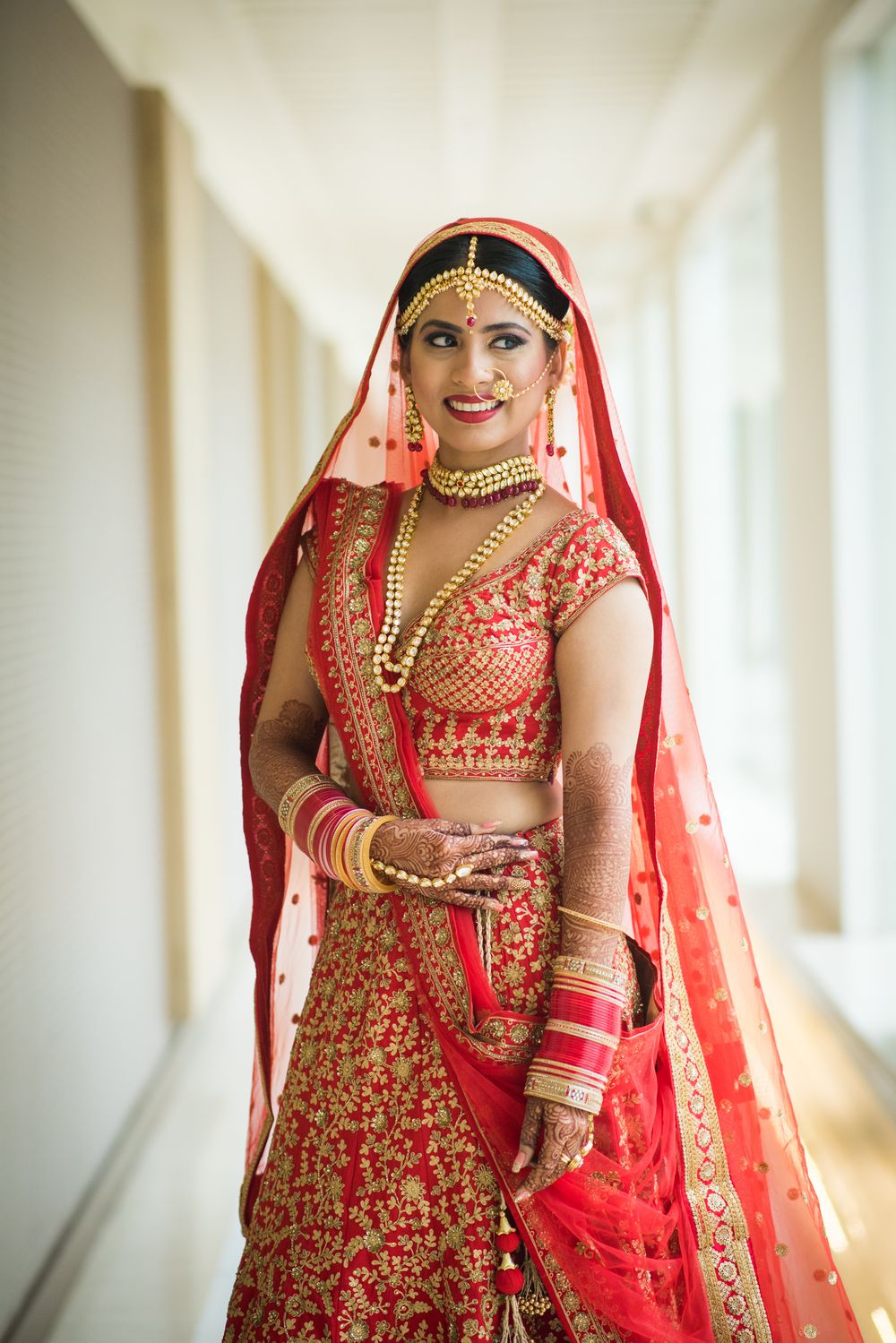 Photo of Bridal look in red lehenga with unique blouse