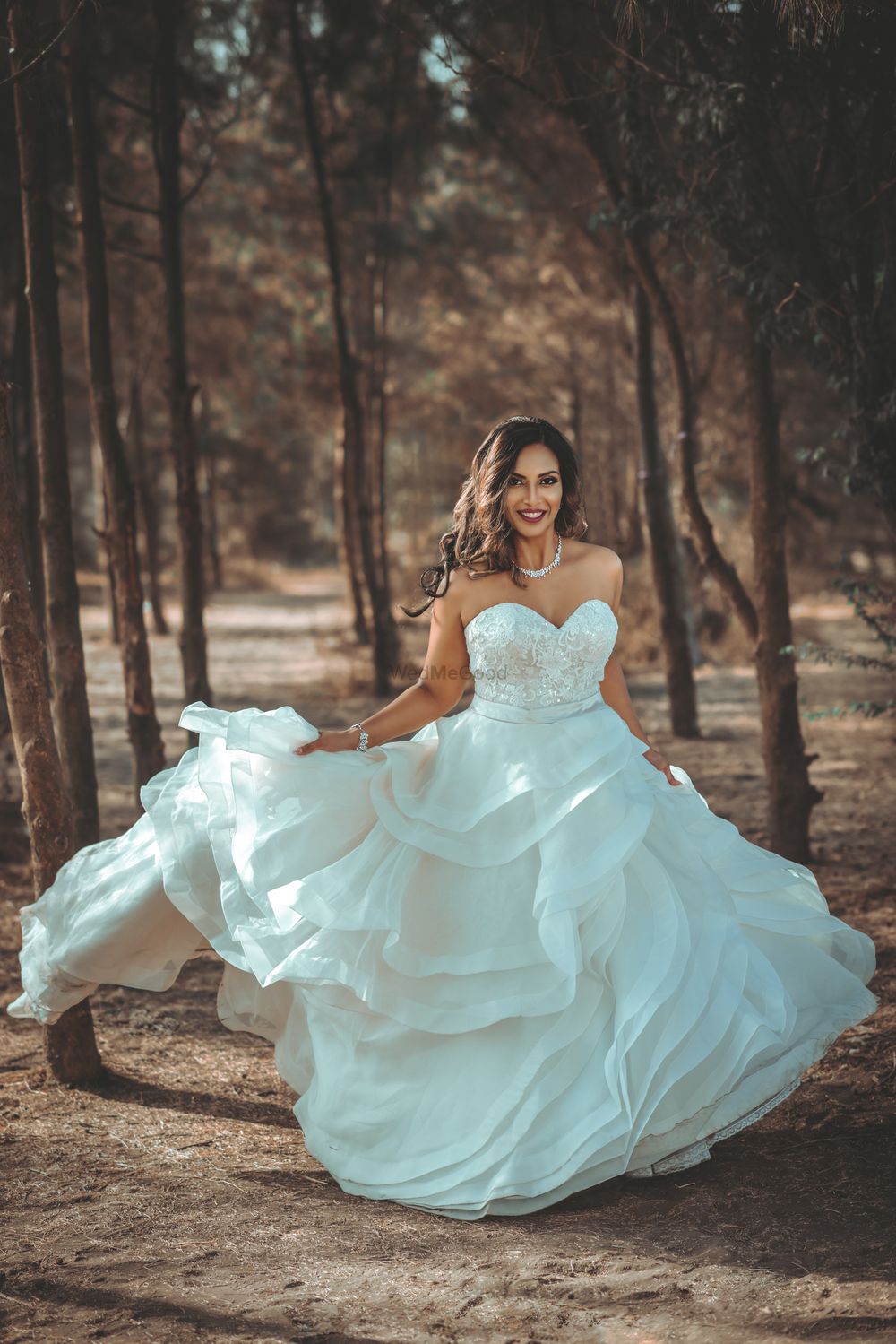 Photo of Layered white wedding strapless gown