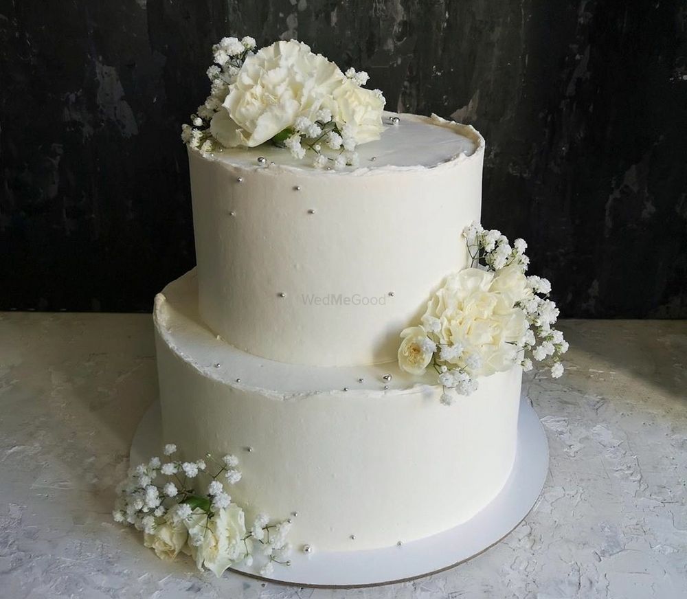 Photo of A two-tier engagement cake with flowers.