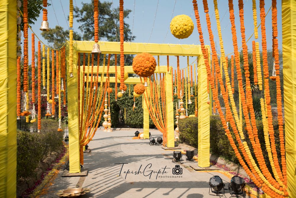 Photo of Entrance way decor with marigolds in yellow and orange