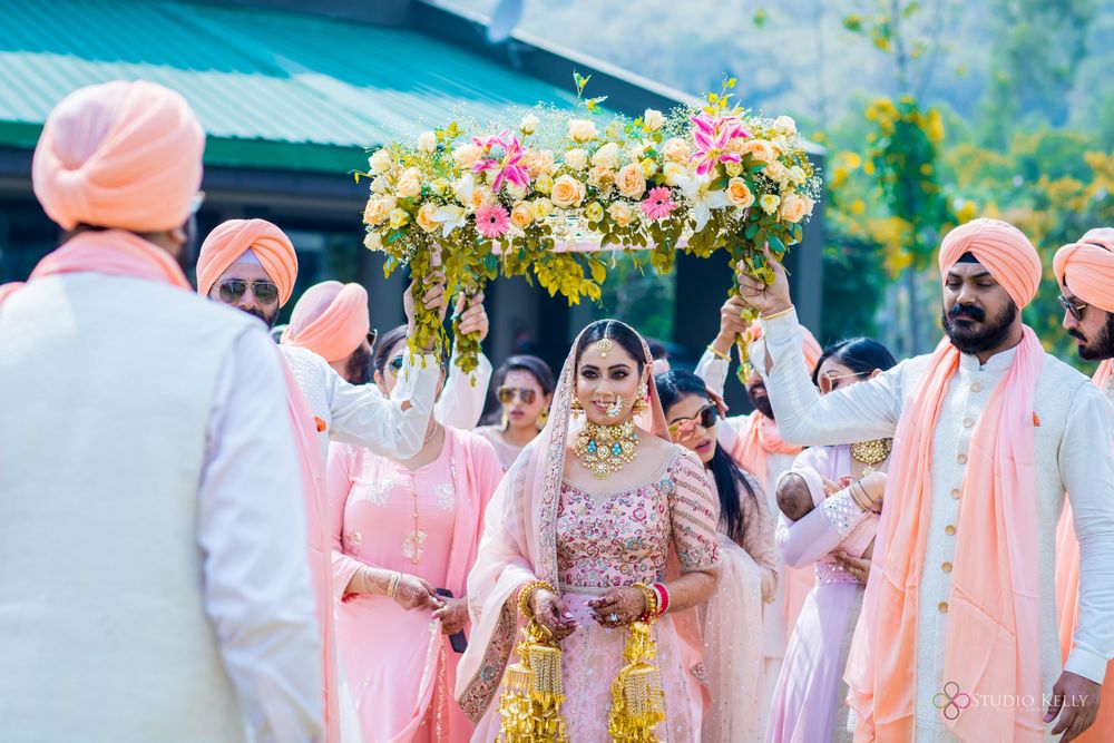 Photo of A Sikh bride entering under a phoolon ki chaadar