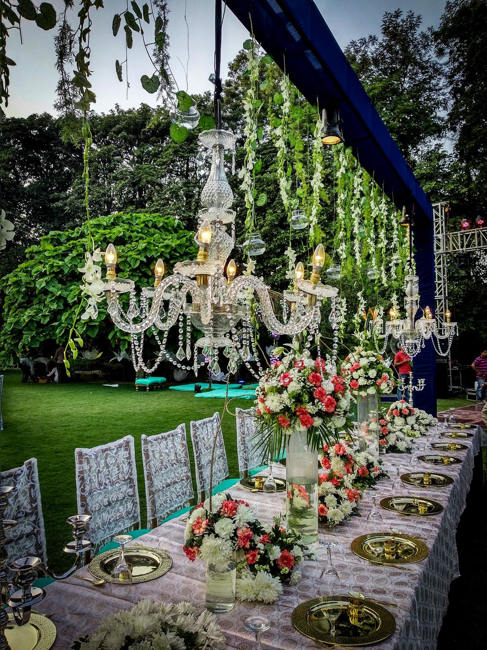 Photo of Intimate long table setting with hanging chandeliers
