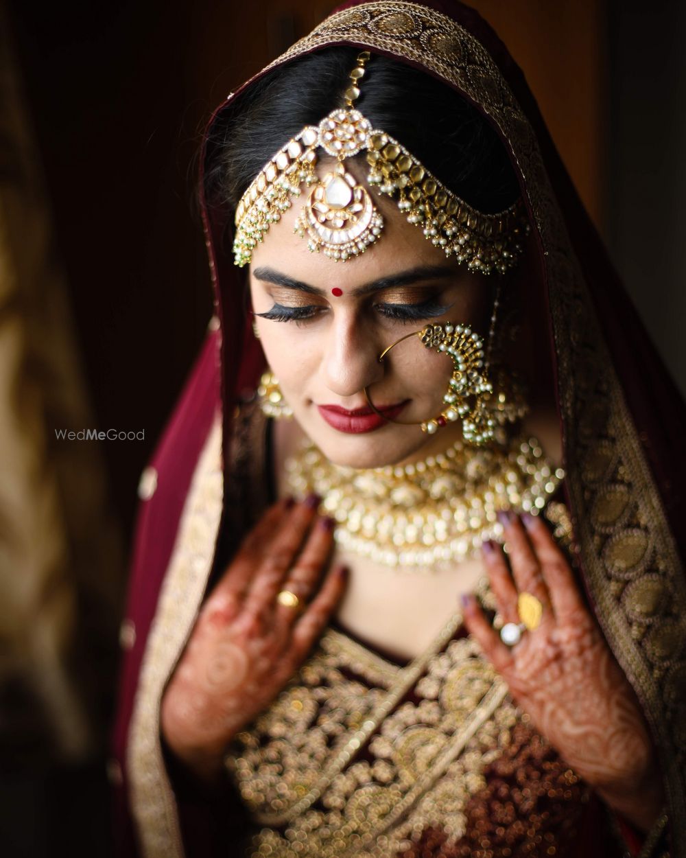 Photo of Oversized Nath with mathapatti and maroon lehenga