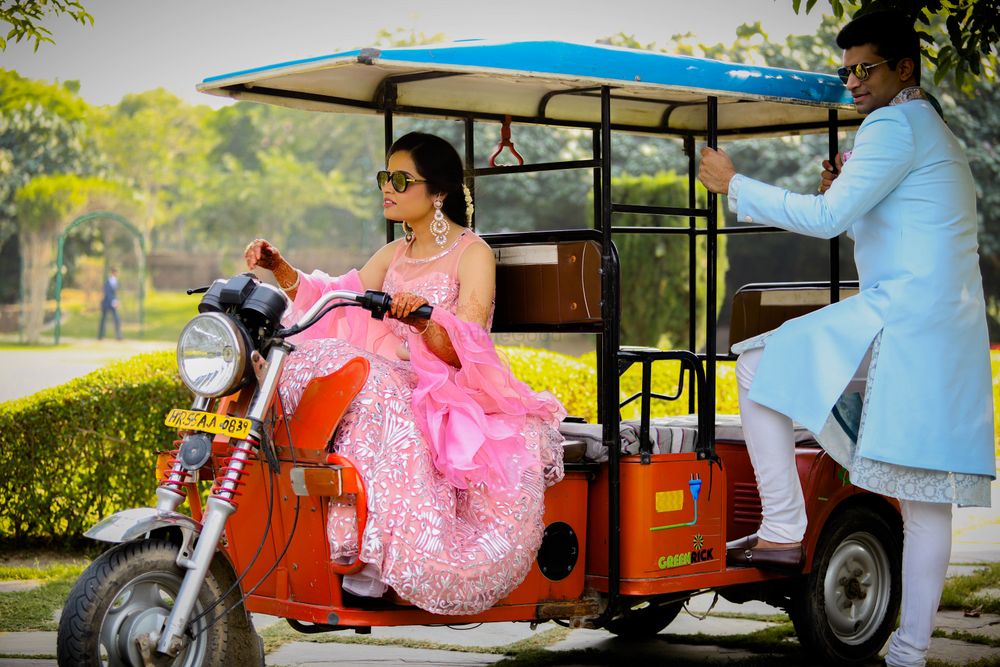 Photo of couple entry on mehendi with bride driving golf cart