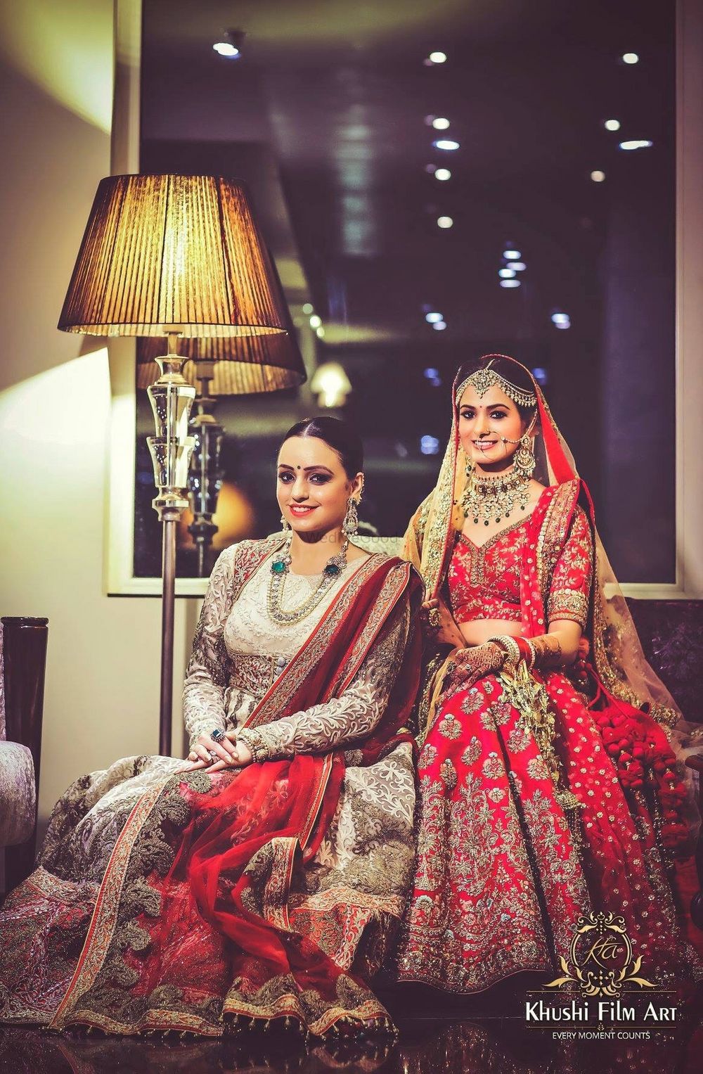 Photo of A bride sits with her sister on the wedding day
