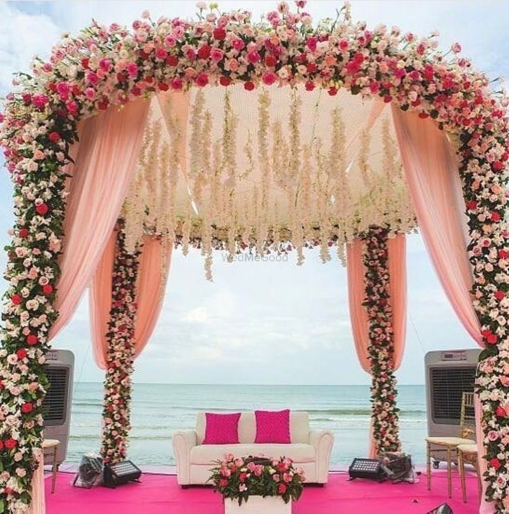 Photo of Floral beachside wedding mandap with sofa