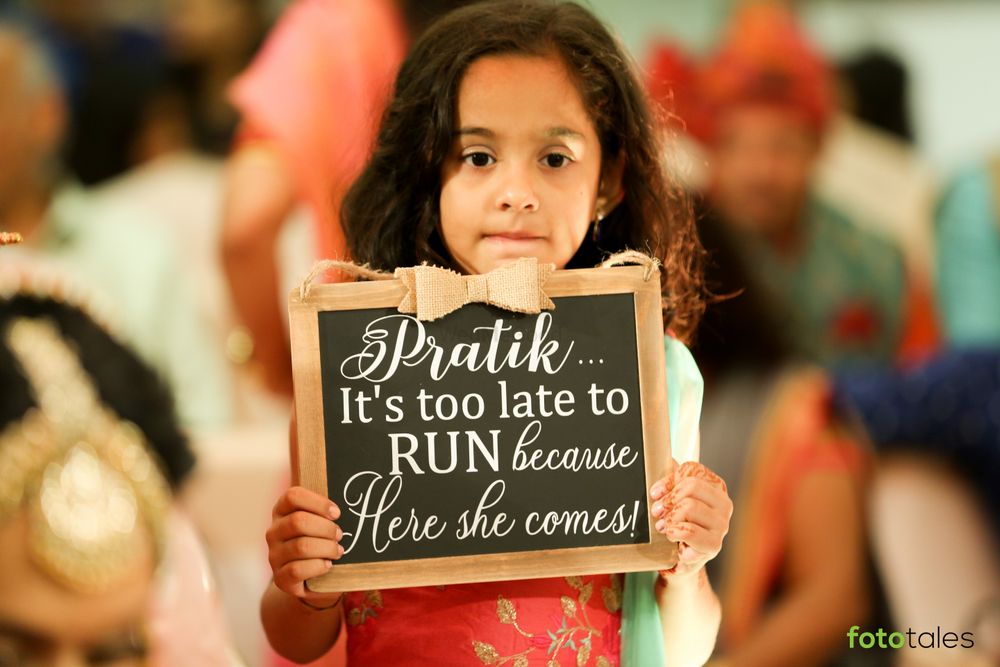 Photo of Kids at weddings holding signages during bridal entry.