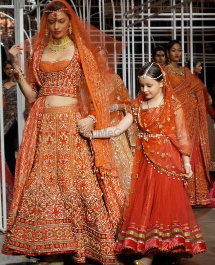 Photo of Red and orange heavy bridal lehenga