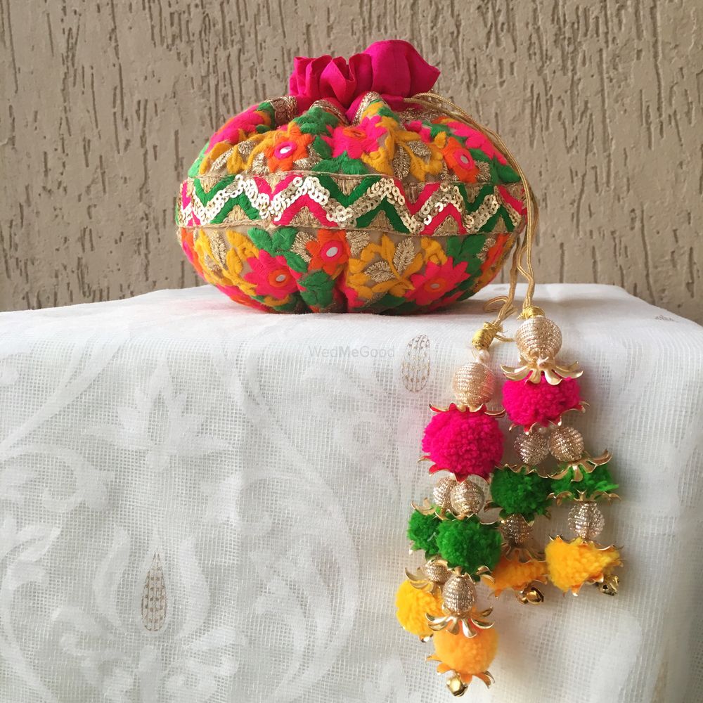 Photo of Colourful potli for mehendi with hanging pompoms