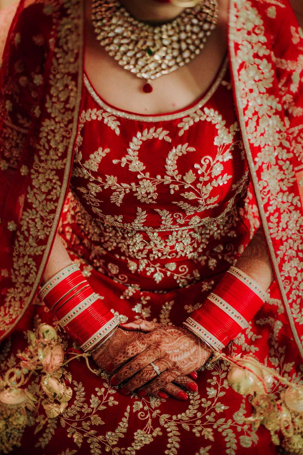 Photo of Bridal hands close up with red chooda