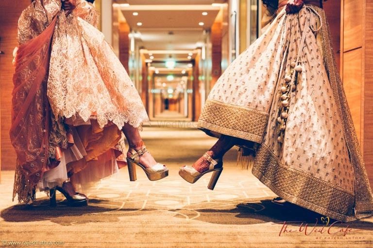 Photo of Cute bride with sister photo showing off heels