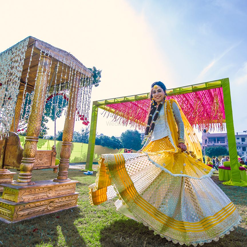 Photo of Happy twirling bride yellow lehenga