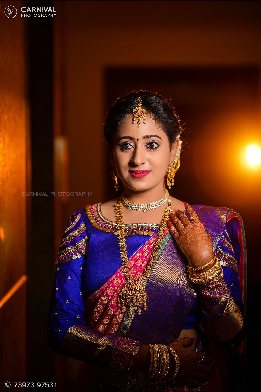 Photo of South Indian bride wearing a pink and blue saree.