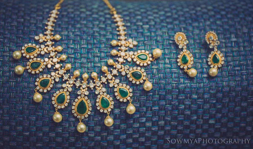 Photo of bridal diamonds and emerald green necklace and earrings