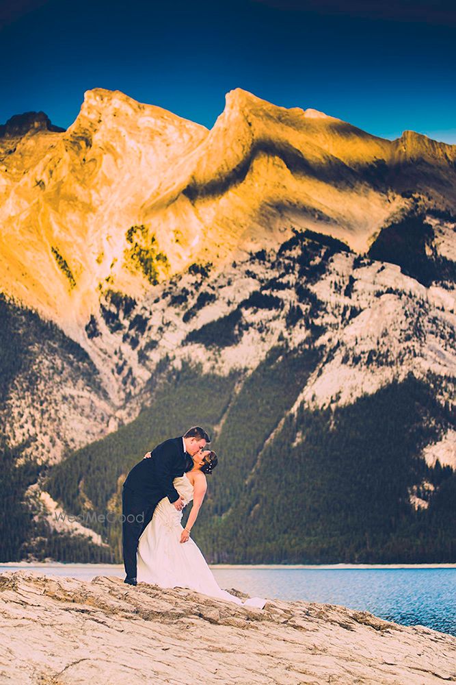 Photo of Christian couple kissing portrait with hilly backdrop