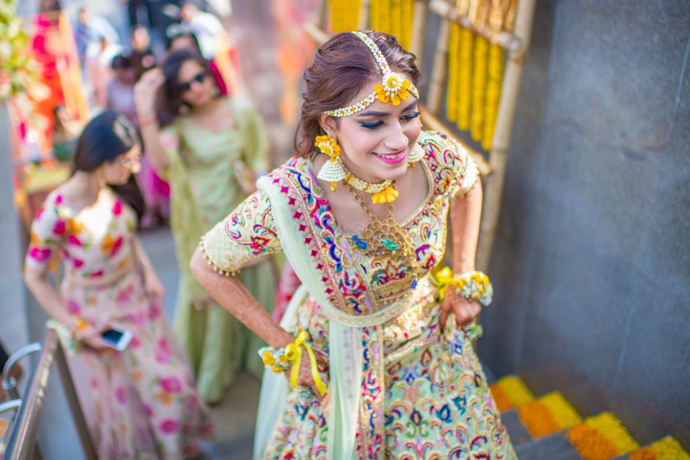 Photo of Mehendi bridal look with floral jewellery and threadwork lehenga