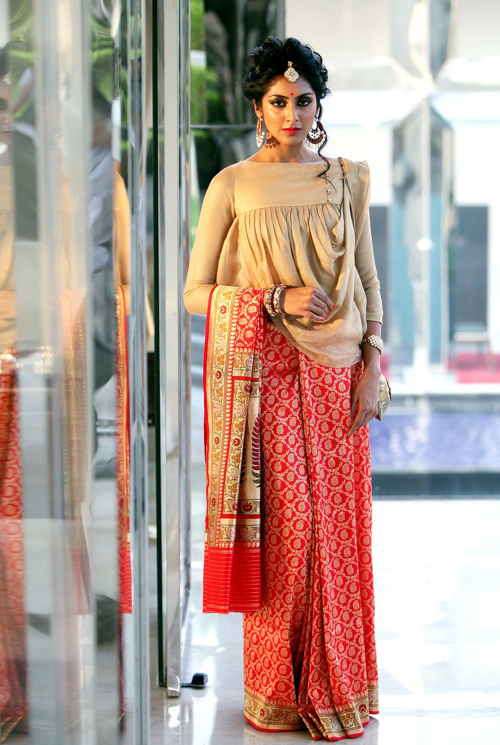 Photo of Unique blouse with draped design and orange saree