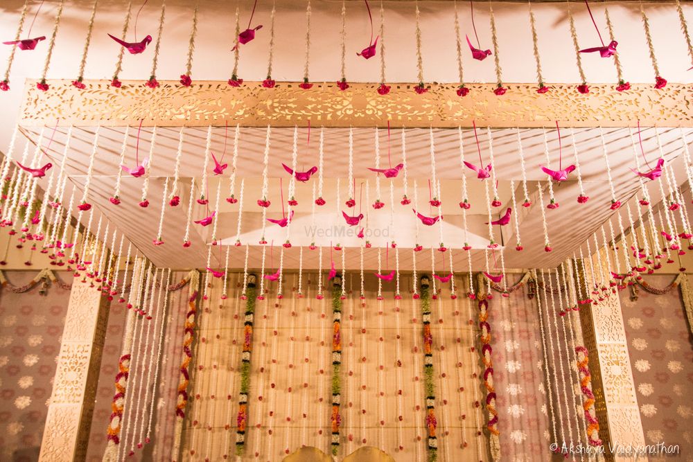 Photo of Pink theme mandap with hanging bird floral arrangement