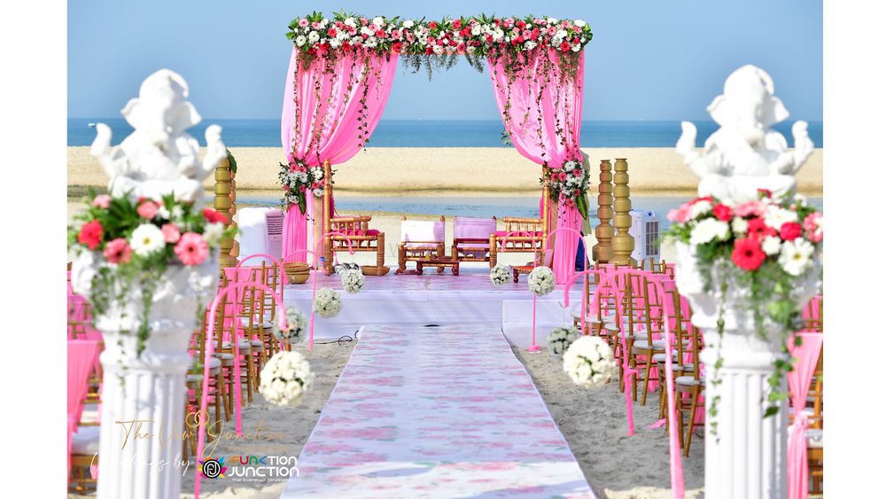 Photo of A draped beachside mandap in pink.