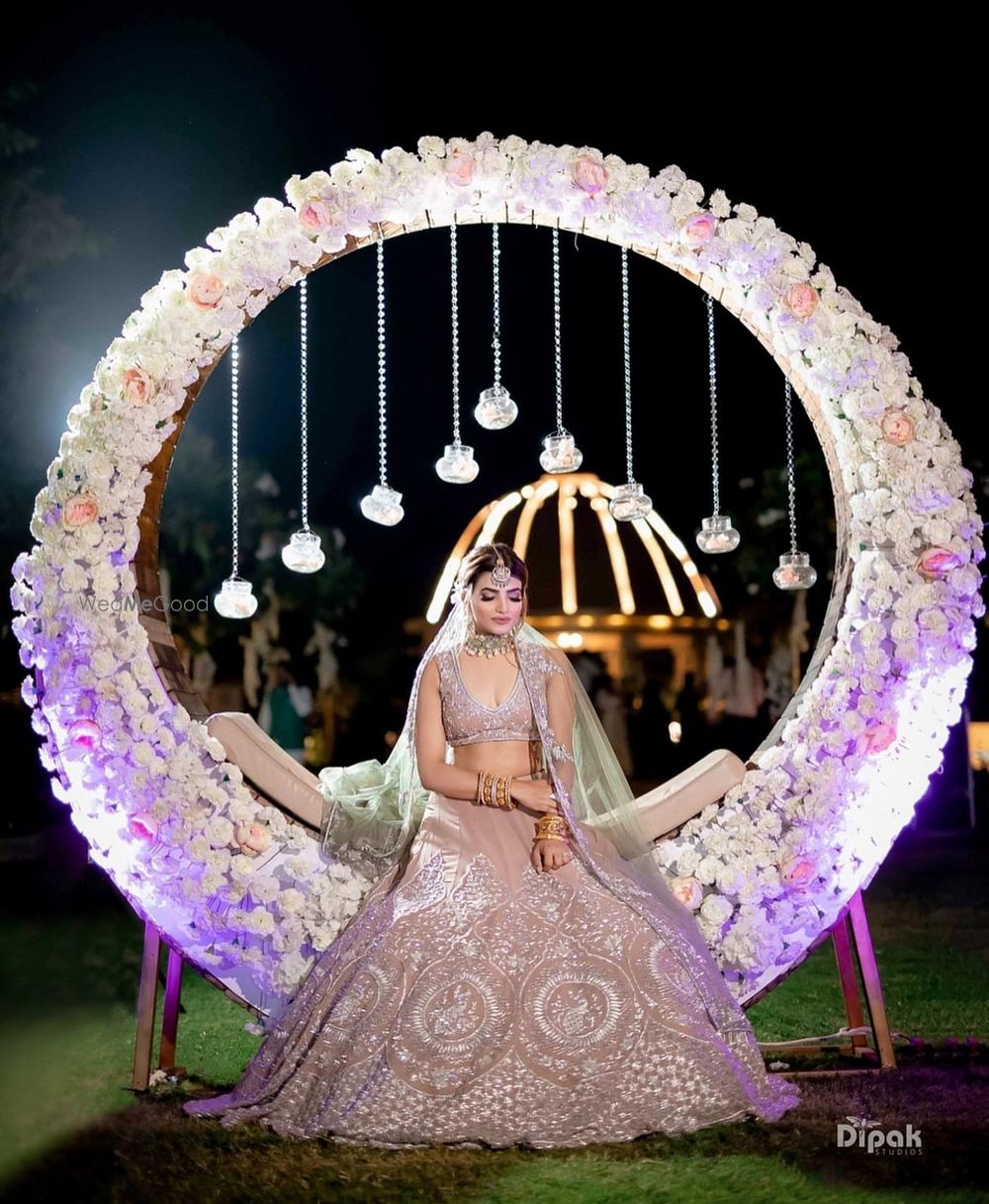 Photo of A huge floral wreath seating for bride