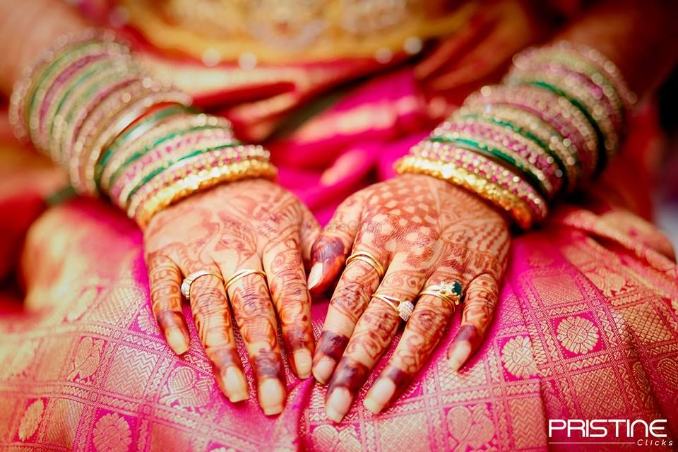 Photo of Traditional Mehendi design on hands with Bangles