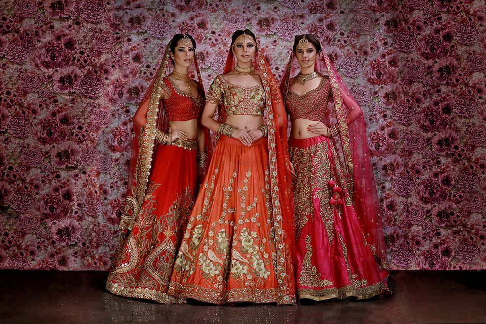 Photo of Red bridal lehengas on models