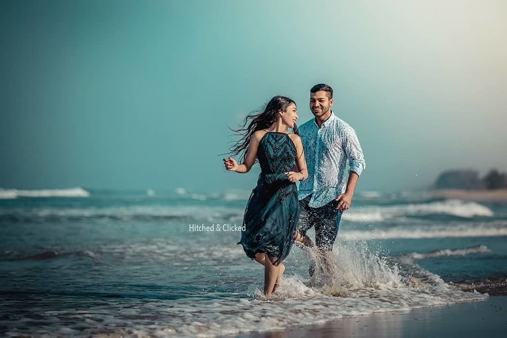 Photo of fun and playful pre wedding shot on the beach