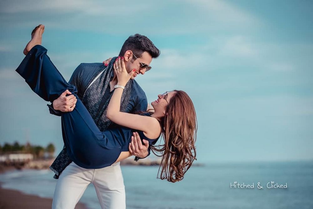 Photo of romantic honeymoon shoot idea with groom picking bride