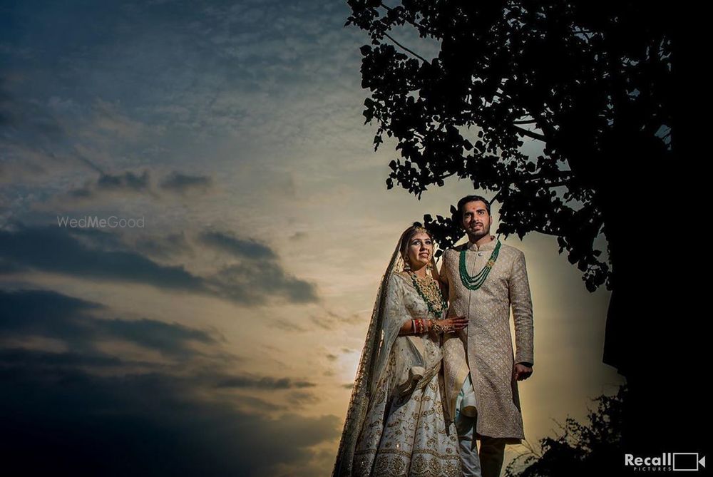 Photo of wedding day couple sunset shot with both wearing matching outfits