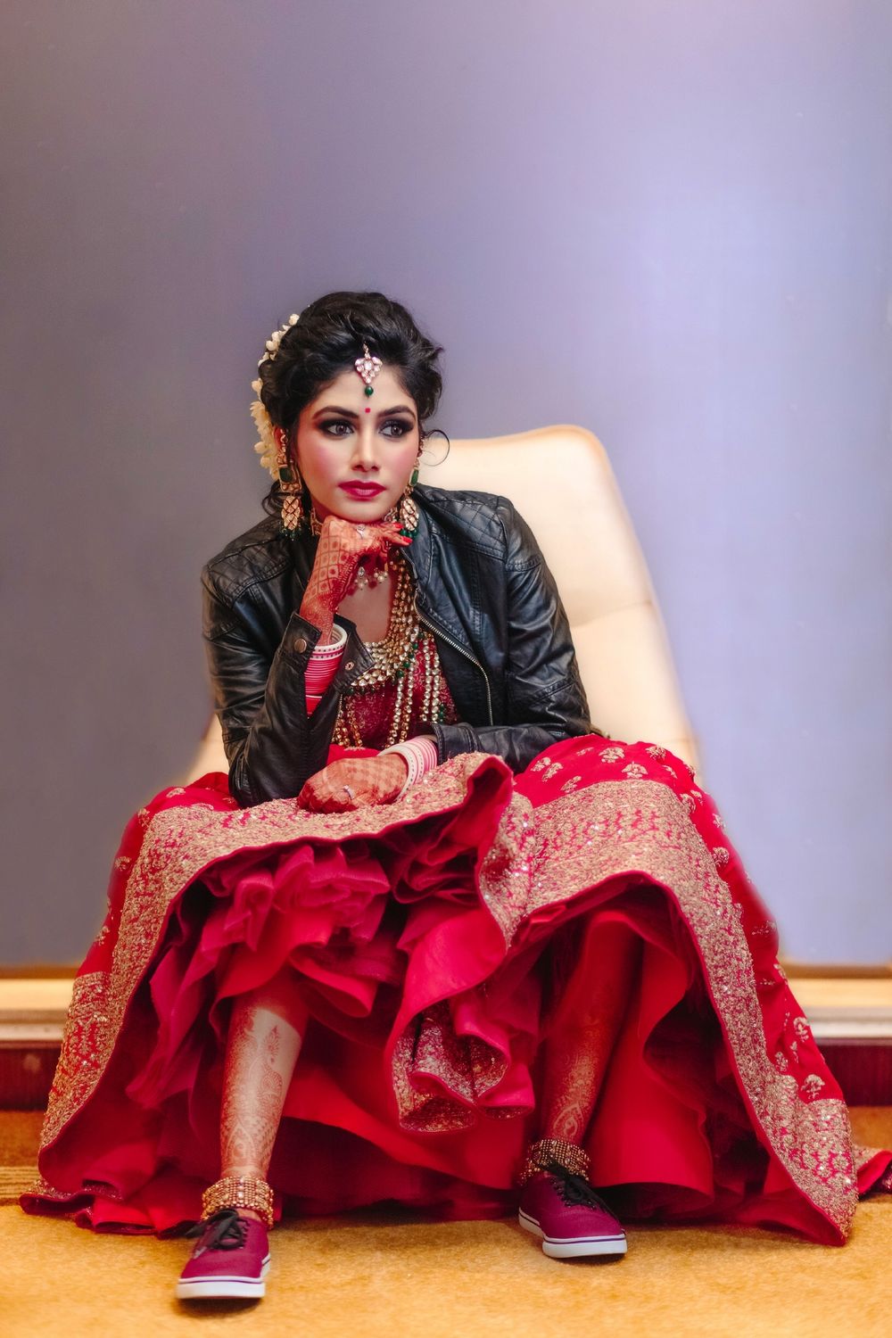 Photo of Offbeat modern bride in lehenga leather jacket and sneakers