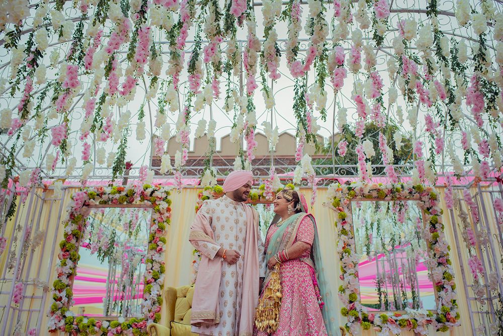 Photo of Pastel couple and decor with floral strings