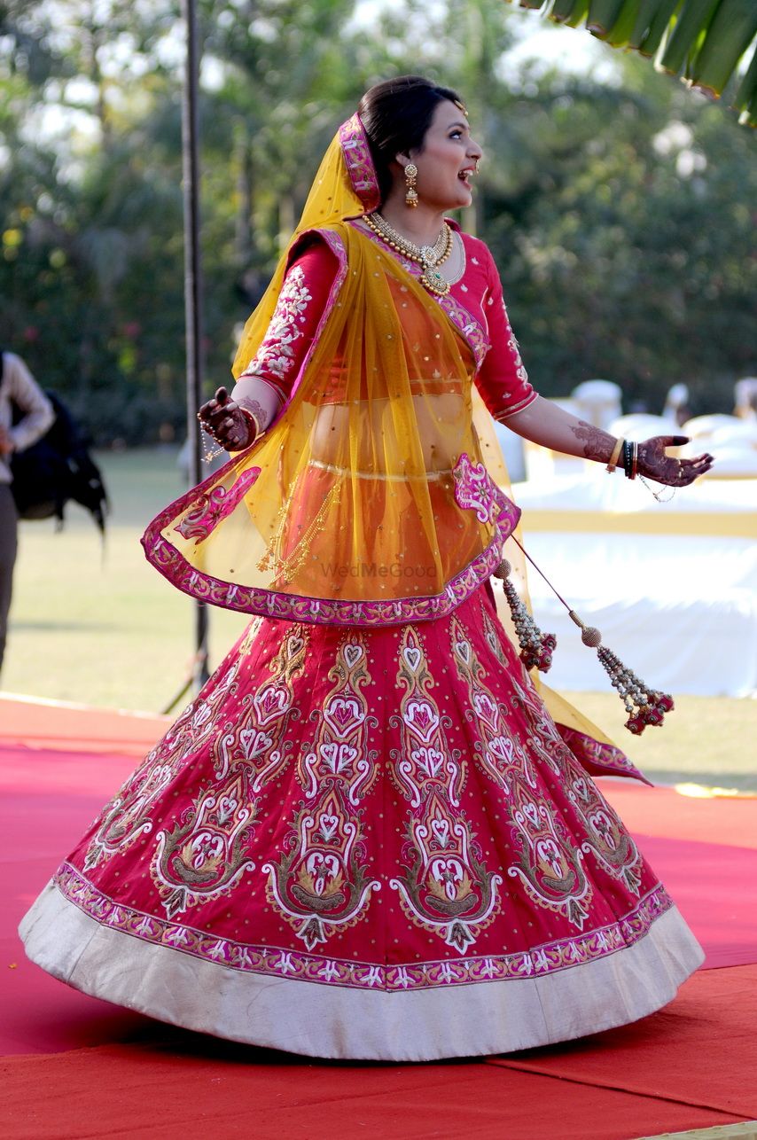 Photo of Bright pink light bridal lehenga with yellow dupatta