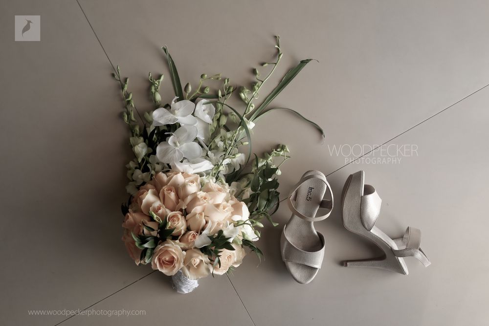 Photo of A unique bridal bouquet and a stunning pair of bridal shoes.