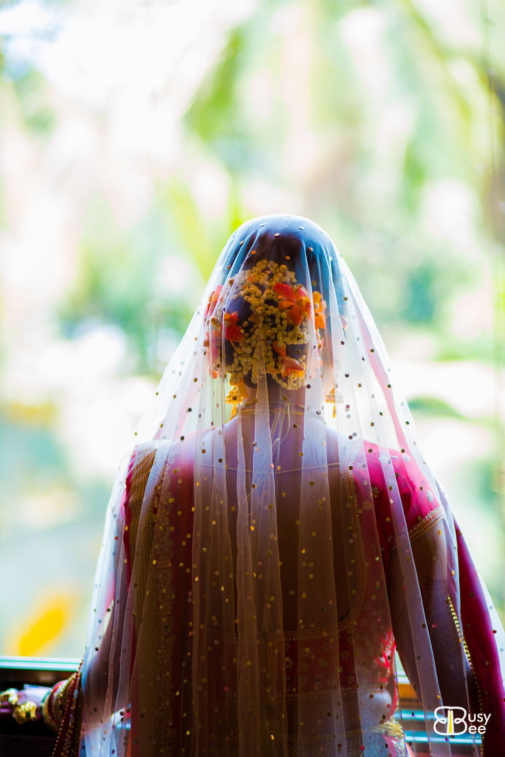 Photo of Bridal hairstyle with orange flowers and dupatta