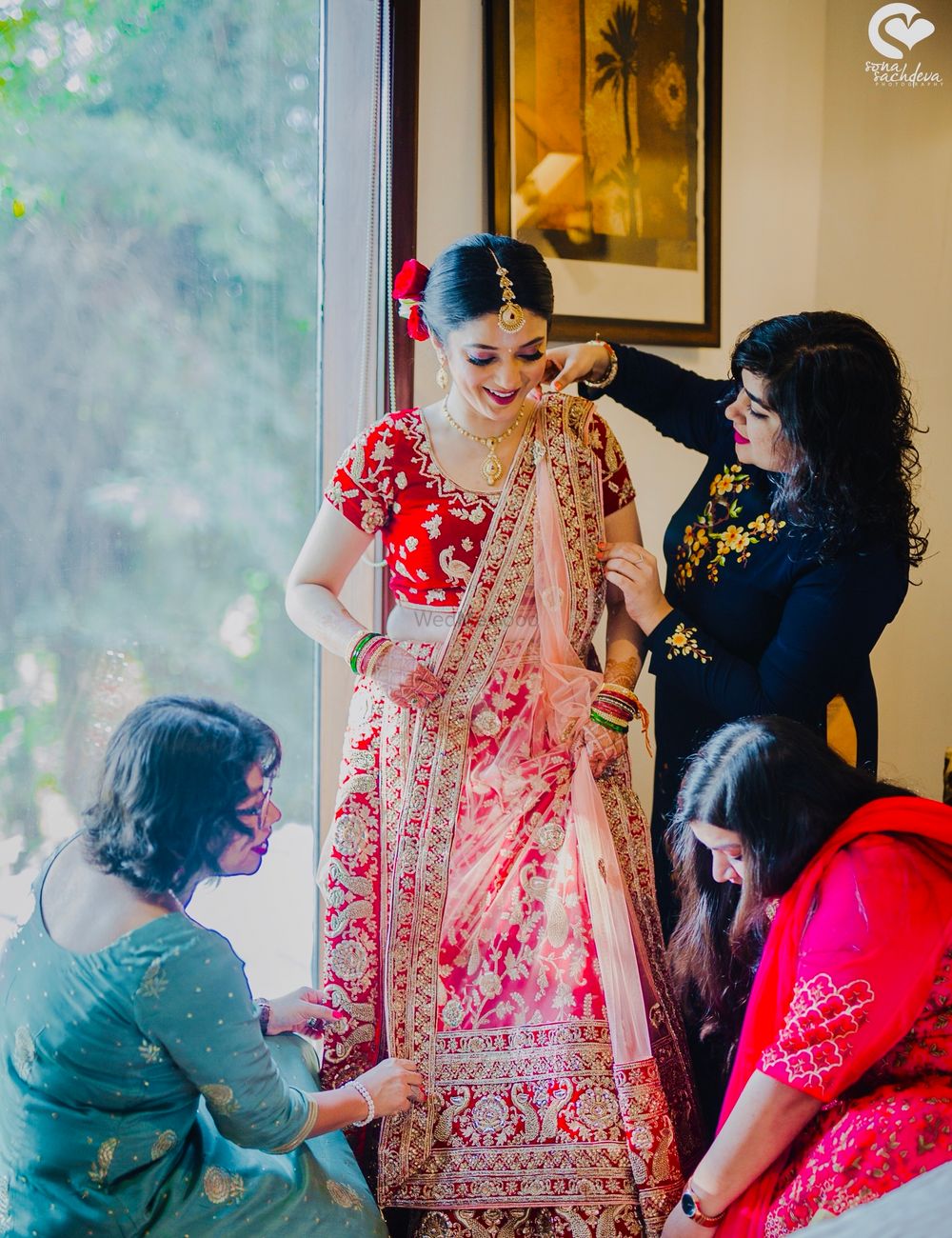 Photo of Bride with bridesmaids getting ready shot idea