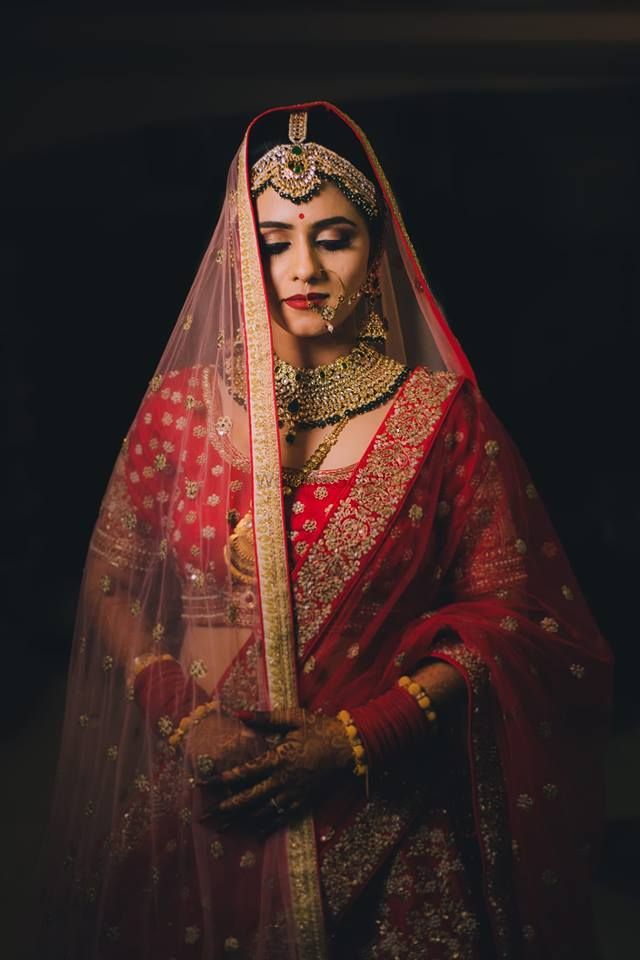 Photo of A bride in red lehenga wearing double dupatta