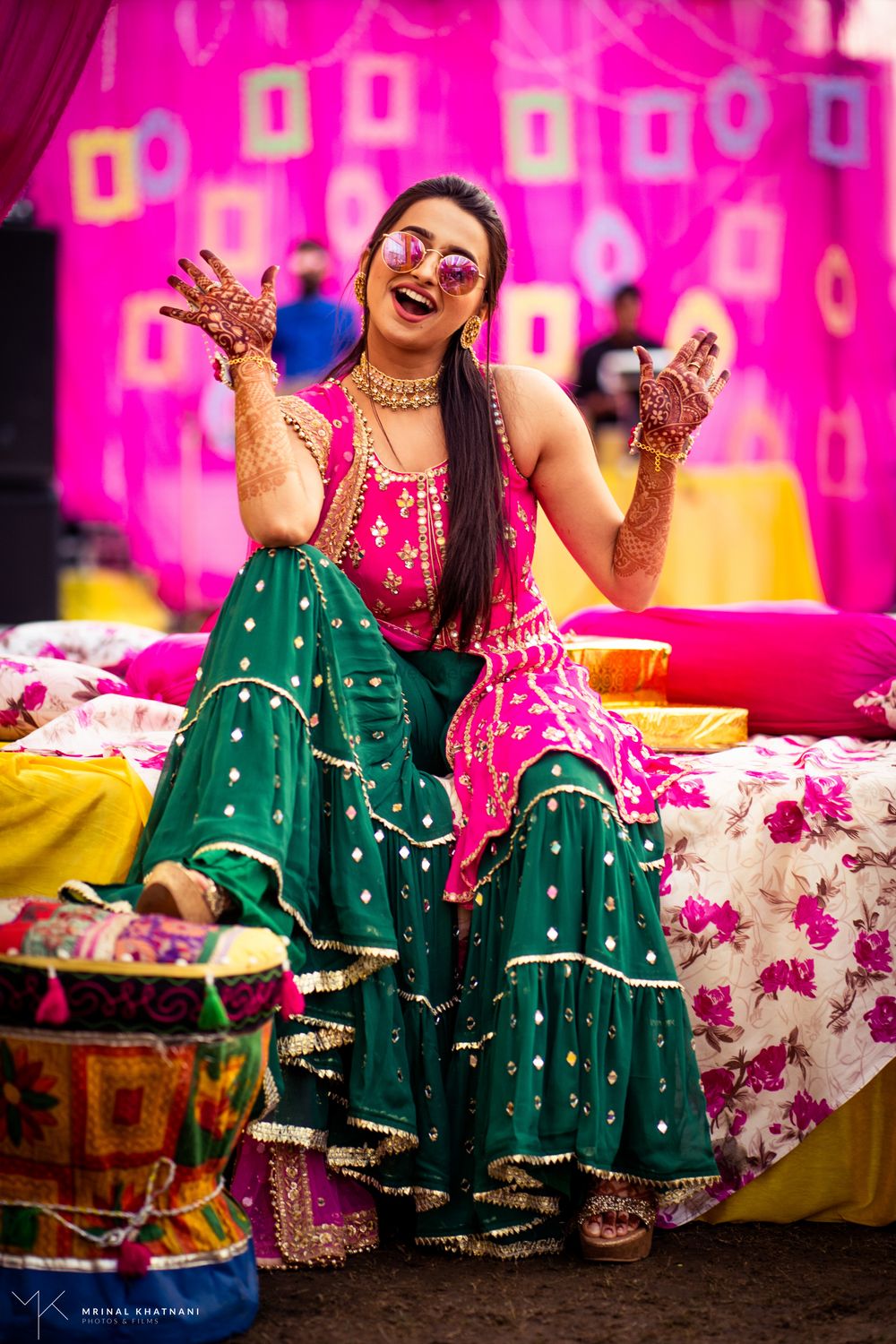 Photo of happy bride shot in dark green and pink mehendi outfit