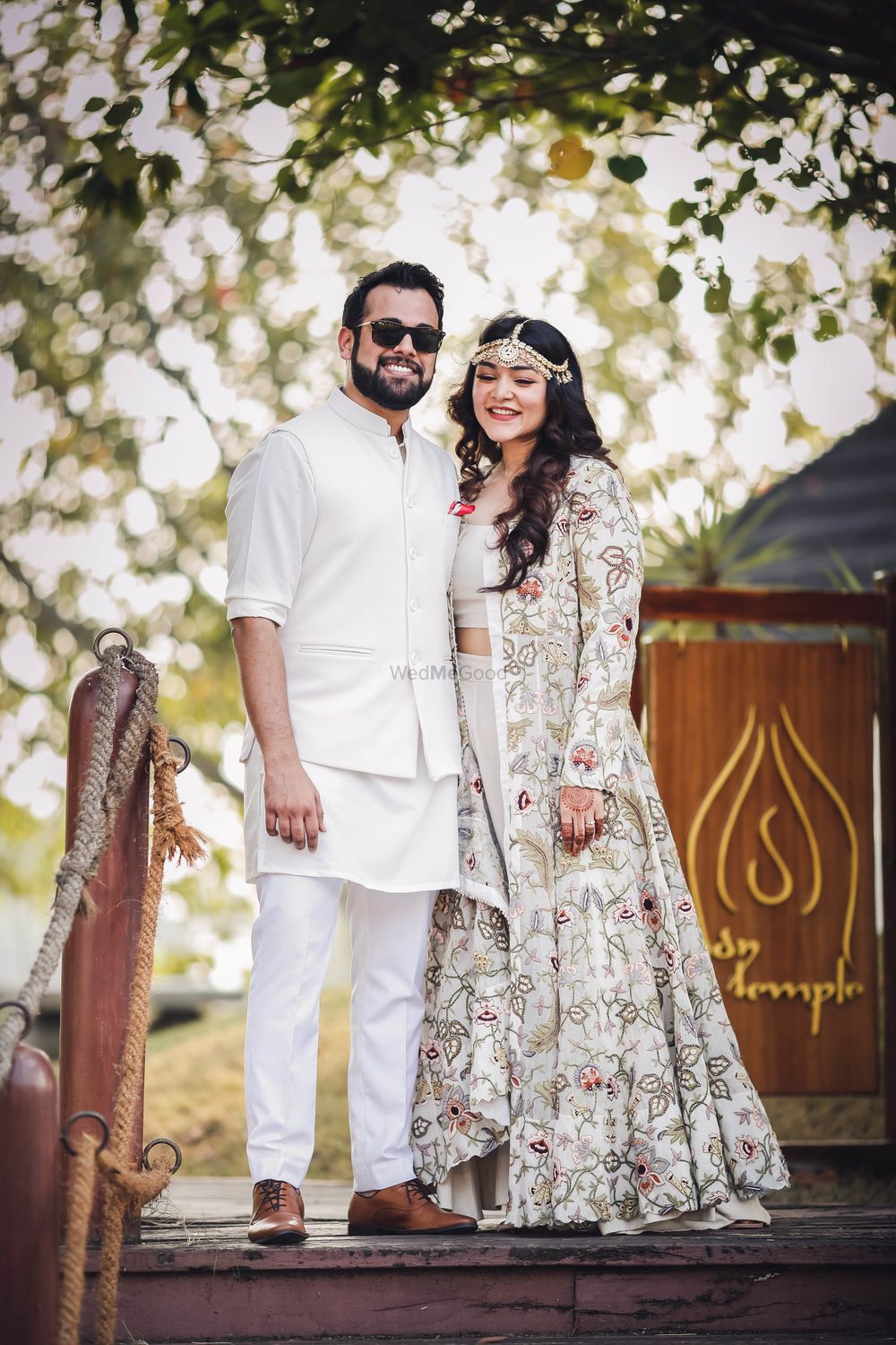 Photo of Matching bride and groom in white mehendi portrait
