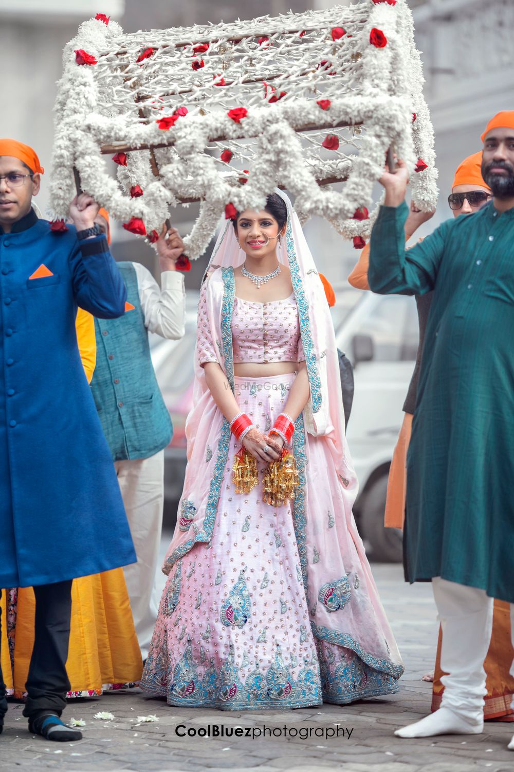 Photo of Sikh Bride Wearing Light Pink Lehenga with Blue Stones