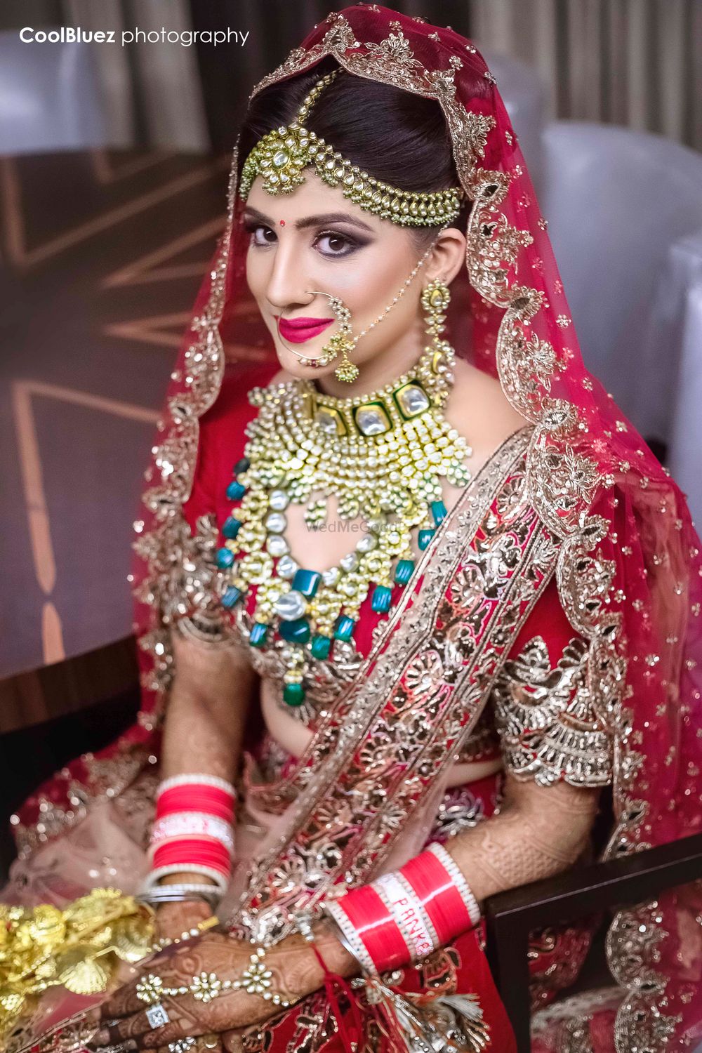 Photo of Red bridal lehenga with blue necklace