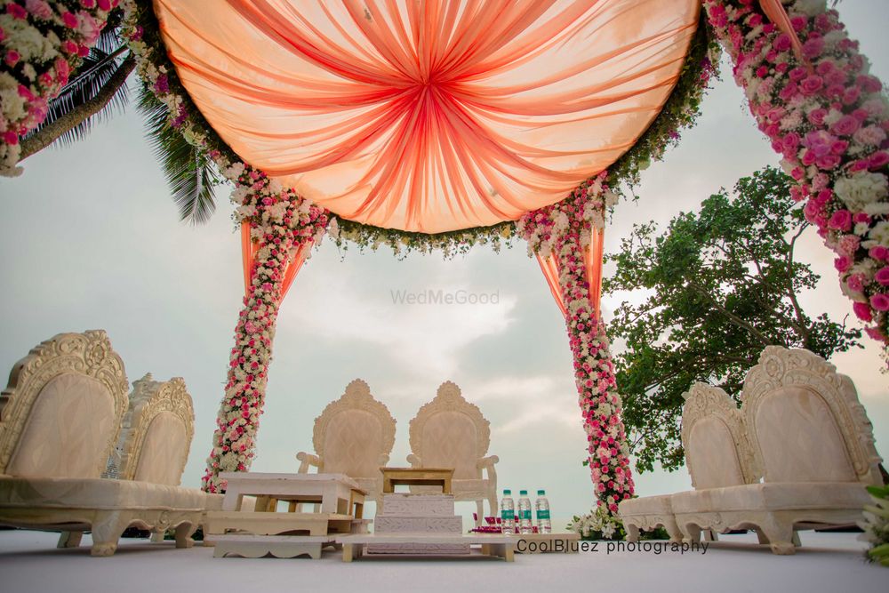 Photo of Day wedding peach mandap with white chairs