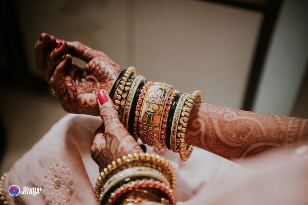 Photo of A shot of a bride's hands with bangles!